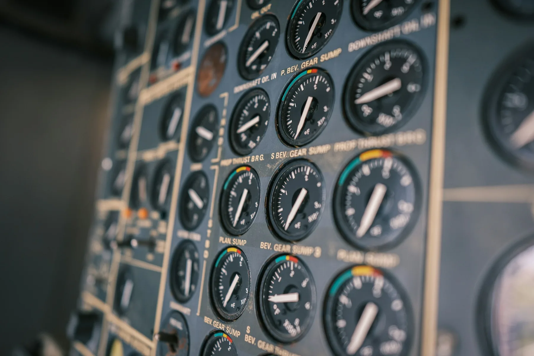 Close-up of an aircraft instrument panel with rows of engine gauges.